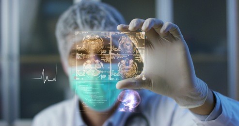 a physician, surgeon, examines a technological digital holographic plate represented the patient's body, the heart lungs, muscles, bones. concept: futuristic medicine, world assistance, and the future
