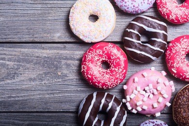 assorted donuts with chocolate frosted, pink glazed and sprinkles donuts.