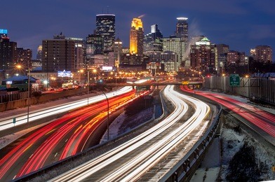 heavy traffic flowing into minneapolis on a busy winter evening.