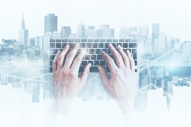 hands using abstract keyboard on white city background. technology concept. double exposure