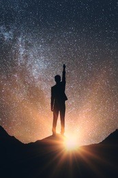 back view of man in space reaching out for the stars. dreams concept