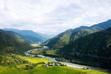bhutan punakha valley countryside with rice fields mountains river and hills at sunset panorama landscape