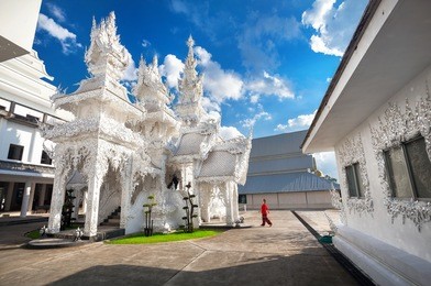 woman in red shirt in wat rong khun the white temple in chiang rai, thailand