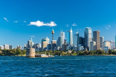 sydney cityscape with sydney tower and sydney cbd skyscrapers with yachts over sydney harbour on sunny day