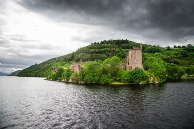 urquhart castle sits beside loch ness in the highlands of scotland.