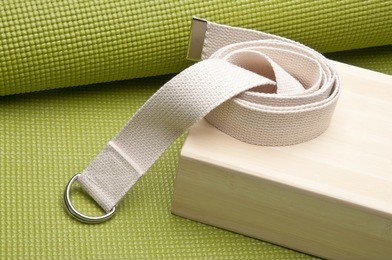 yoga practice equipment : mat, strap and bamboo block.