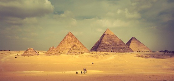 egyptian pyramids of giza plateau: famous pyramid of menkaure, khafre,  khufu and three smaller step pyramids. panoramic view of giza pyramid complex, idea of horizontal banner for travel to egypt.