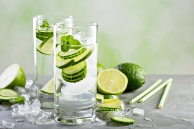 cold and refreshing infused detox water with lime and cucumber in a glass