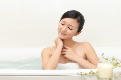 young beautiful woman taking relaxing bath