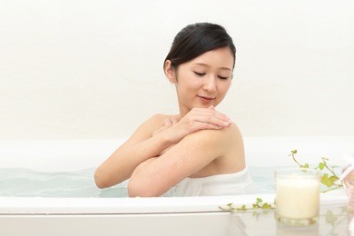 young beautiful woman taking relaxing bath