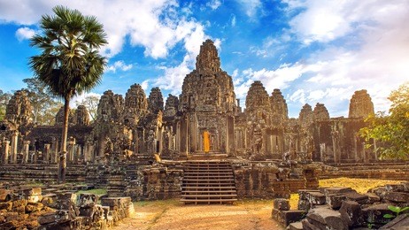 ancient stone faces at sunset of bayon temple, angkor wat, siam reap, cambodia.