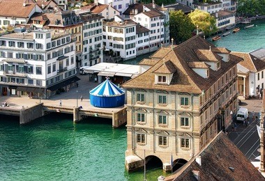 old town hall and carousel at river limmat in zurich, switzerland