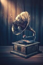 vintage gramophone on a wooden background with dramatic lighting
