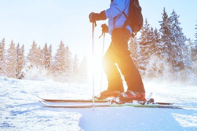 skiing downhill, skier in winter forest mountains, background