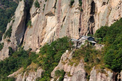 a building being built on the rocky cliffs in the fangdong scenic area of yandangshan located in zhejiang province china.   