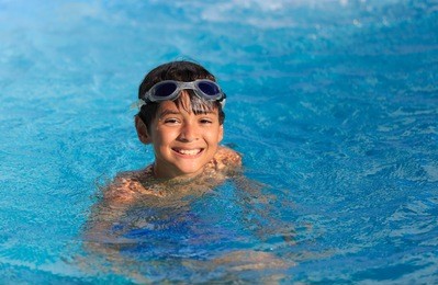boy swimming and playing in a pool