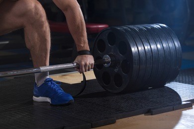 sports background. young athlete getting ready for weight lifting training.