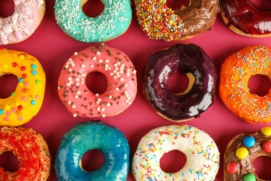 glazed donuts on color background