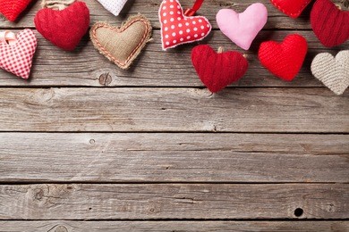 valentines day greeting card. handmaded hearts on wooden table. top view with copy space  