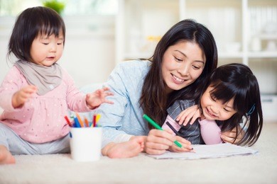 pretty happy japanese mother play with her two cute little daughters at home