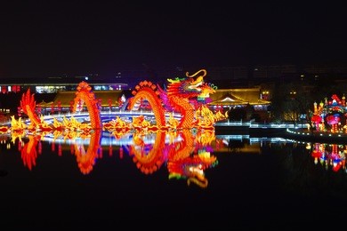 reflection of the tang paradise center at night, xi'an, china.xi 'an datang furong garden lanterns