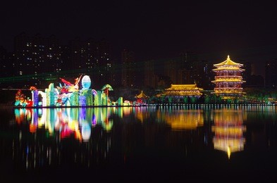 reflection of the tang paradise center at night, xi'an, china.xi 'an datang furong garden lanterns