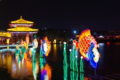 reflection of the tang paradise center at night, xi'an, china.xi 'an datang furong garden lanterns