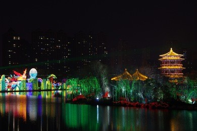reflection of the tang paradise center at night, xi'an, china.xi 'an datang furong garden lanterns