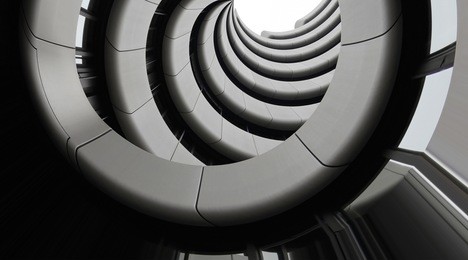 modern architecture. underside view of curvilinear balconies. public or office building exterior fragment. modular architectural structures. industry or technology motif.