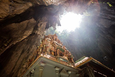 the batu caves lord murugan statue and entrance in kuala lumpur, malaysia. batu caves has three main caves featuring temples and hindu shrines.