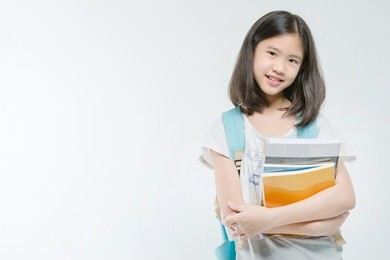 young asian student girl holding books on isolated background