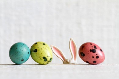 easter eggs and bunny ears abstract background on white boards