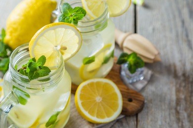 classic lemonade in glass jars, wood background