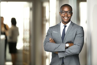 handsome cheerful african american executive business man at the workspace office 