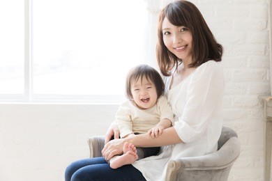 portrait of asian mother and baby relaxing in the room