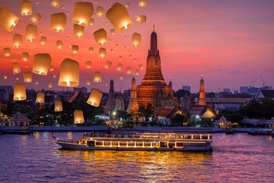 wat arun and cruise ship in night time and floating lamp in yee peng festival under loy krathong day, bangkok city ,thailand