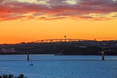 sunset over the harbour bridge auckland new zealand
