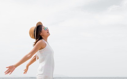 happy beauty woman in hat is back opened his hands, beautiful serene relaxing woman in pure happiness and elated enjoyment , asian caucasian female model.20-30years