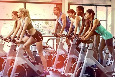 fit people working out at spinning class in the gym
