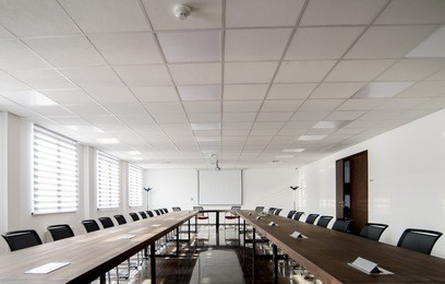 conference room interior with empty chairs and a projector screen