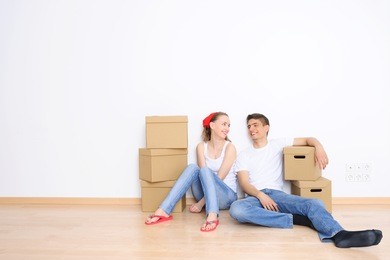 young couple resting from moving into a new home. great copy space.