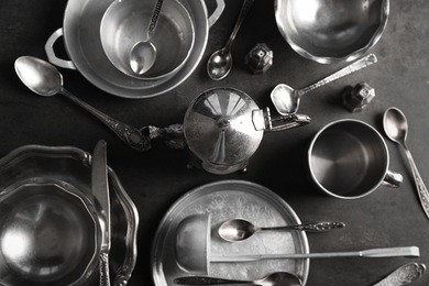 set of dishes and cutlery on gray background