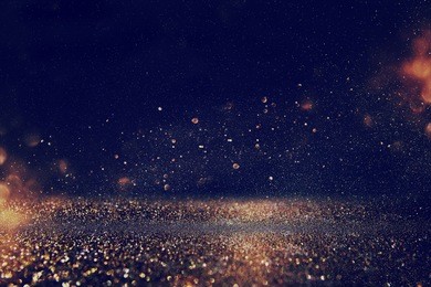 glitter vintage lights background. gold, blue and black. de-focused