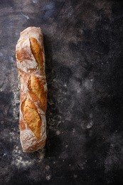 fresh baguette bread on dark background copy space