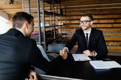 sell concept. two men get an agreement and shake hands.