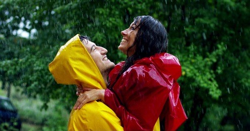 two teenagers or adults are kissing under the rain like lovers. couple  have fun and enjoy life, nature around. concept of nature and happy life. adventure, purity, love, attraction,