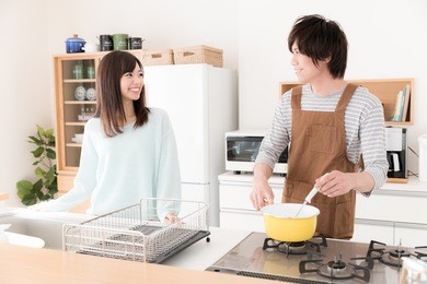 young asian couple cooking in the kitchen