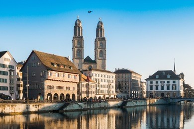 limmat river quay and grossmunster church in zurich, switzerland