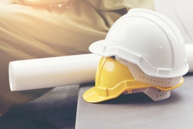 safety helmet hard hat white yellow. protection head safety equipment in construction site.  engineering concept.