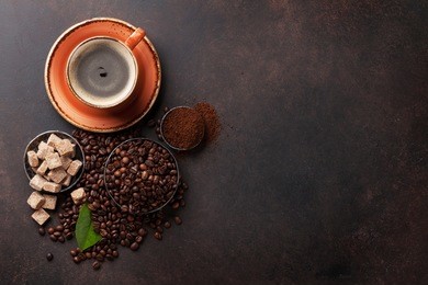 coffee cup, beans and ground powder on stone background. top view with copy space for your text 